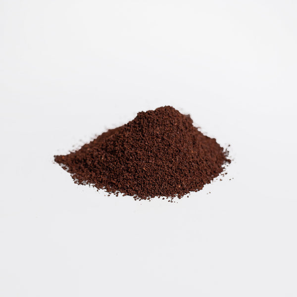 Ground hemp coffee blend from Revita Genix Labs displayed as a small pile of fine dark brown powder