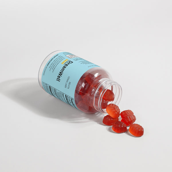 Revita Genix Labs DreamWell sleep gummies bottle with red berry-shaped gummies spilling out on white background