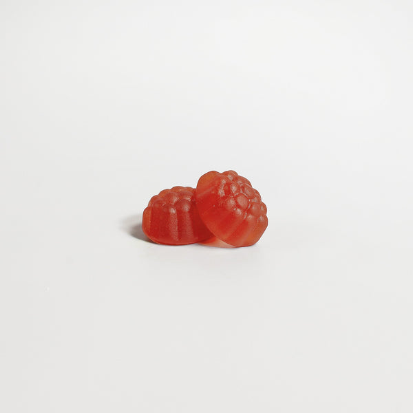 Two reddish DreamWell sleep gummies by Revita Genix Labs specialty supplements on white background