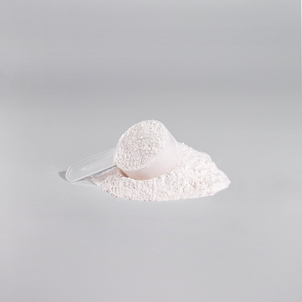 Scoop of white powdered amino acids from Ignite-NO performance booster by Revita Genix Labs