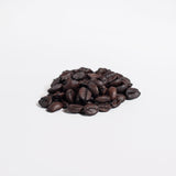 Close-up of dark roasted coffee beans representing premium jungle java from Revita Genix Labs
