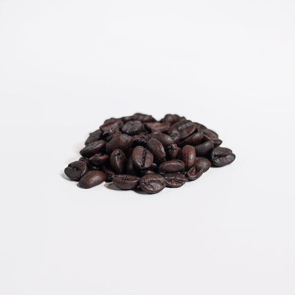 Close-up of dark roasted coffee beans used for Revita Genix Labs Manuka honey coffee blend
